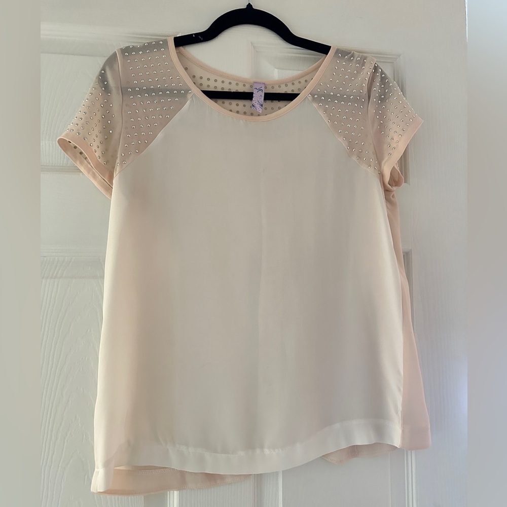 Light pink shirtsleeve blouse with split back and accents on shoulders